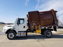 white and brown curbtender Under CDL truck